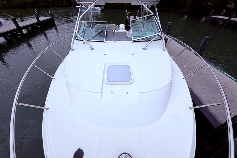 Slide: The Image of 2001 Wellcraft 290 Coastal boat docked, showcasing spacious deck and sleek design. - 50