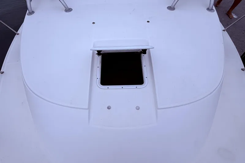 Slide: The Image of 2001 Wellcraft 290 Coastal boat deck with open hatch, showcasing sleek design. - 52