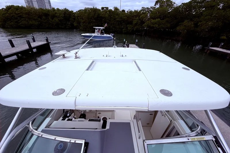 Slide: The Image of 2001 Wellcraft 290 Coastal boat docked near lush greenery and calm waters. - 53