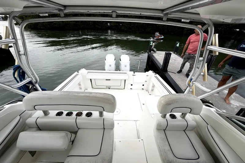 Slide: The Image of 2001 Wellcraft 290 Coastal boat interior at dock, featuring seating and dual engines. - 55