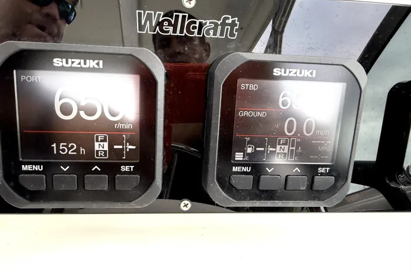 Slide: The Image of Dashboard of a 2001 Wellcraft 290 Coastal boat with Suzuki engine displays. - 62