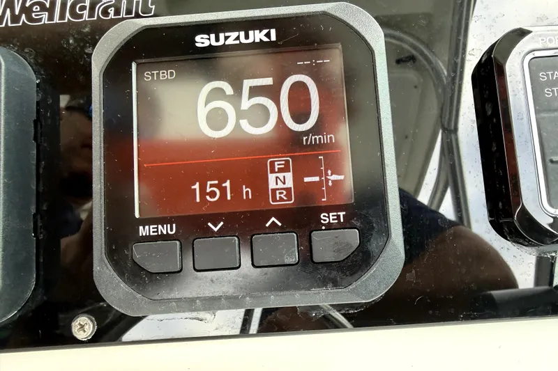 Slide: The Image of Suzuki engine display on 2001 Wellcraft 290 Coastal, showing 650 RPM and 151 hours. - 63