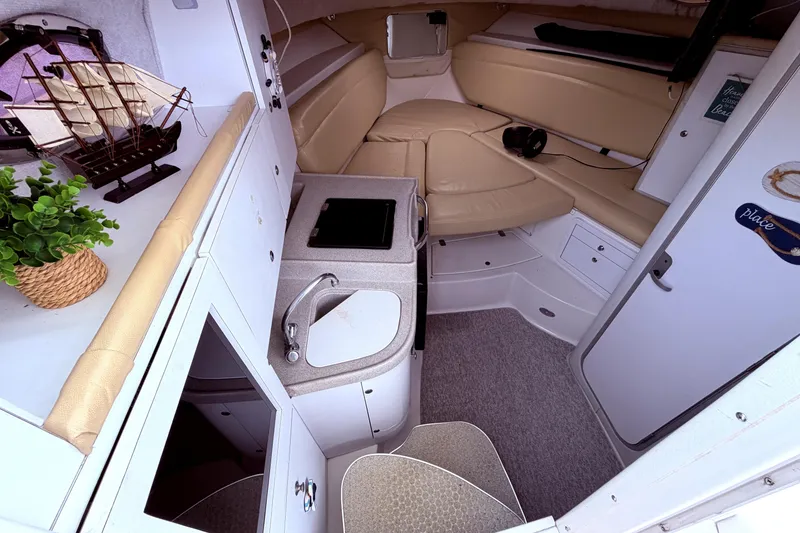 Slide: The Image of Interior of 2001 Wellcraft 290 Coastal boat with kitchenette and seating area. - 78