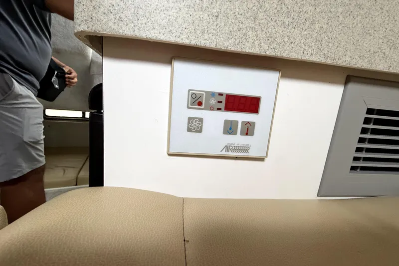 Slide: The Image of Control panel inside 2001 Wellcraft 290 Coastal boat cabin, featuring air conditioning settings. - 79