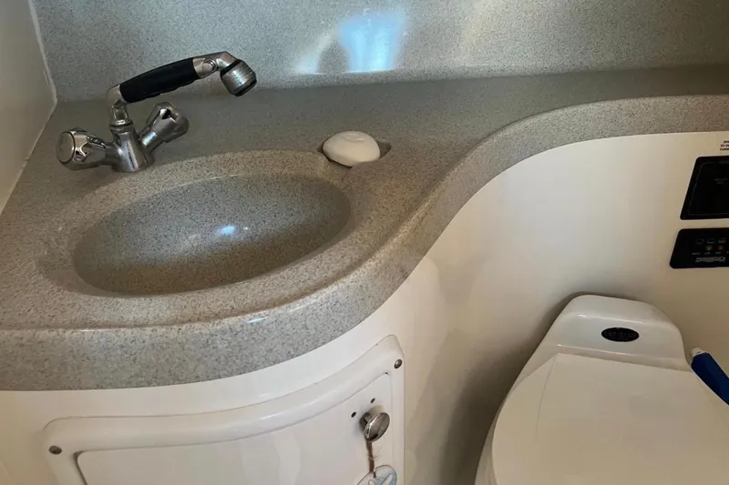 Slide: The Image of 2001 Wellcraft 290 Coastal boat bathroom with sink and toilet. - 80