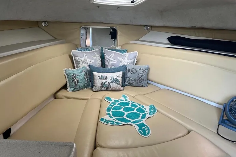 Slide: The Image of Interior of 2001 Wellcraft 290 Coastal boat with decorative pillows and turtle rug. - 82