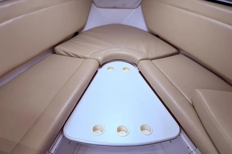 Slide: The Image of Interior seating area of 2001 Wellcraft 290 Coastal boat with beige cushions and table. - 83