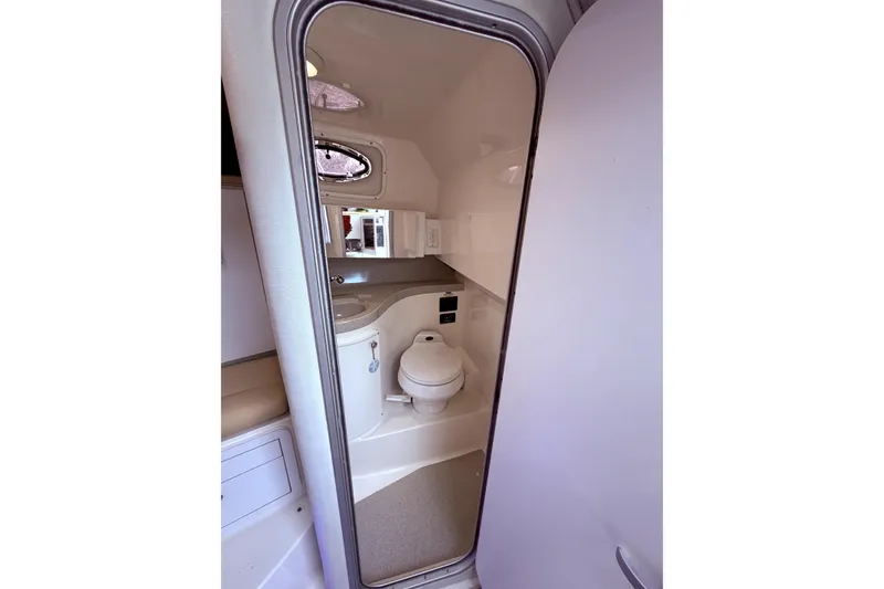 Slide: The Image of 2001 Wellcraft 290 Coastal boat bathroom interior with toilet and mirror. - 89