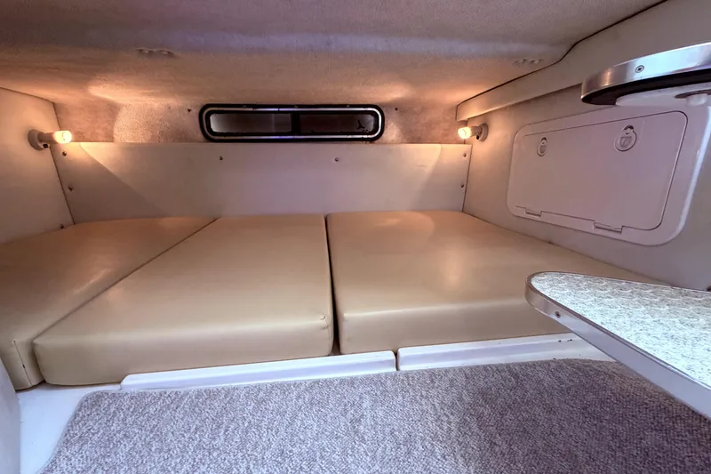 Slide: The Image of 2001 Wellcraft 290 Coastal cabin interior with beige cushions and ambient lighting. - 91