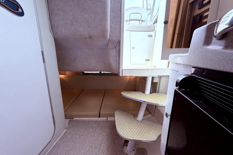 Slide: The Image of 2001 Wellcraft 290 Coastal cabin interior with stairs and sleeping area. - 92
