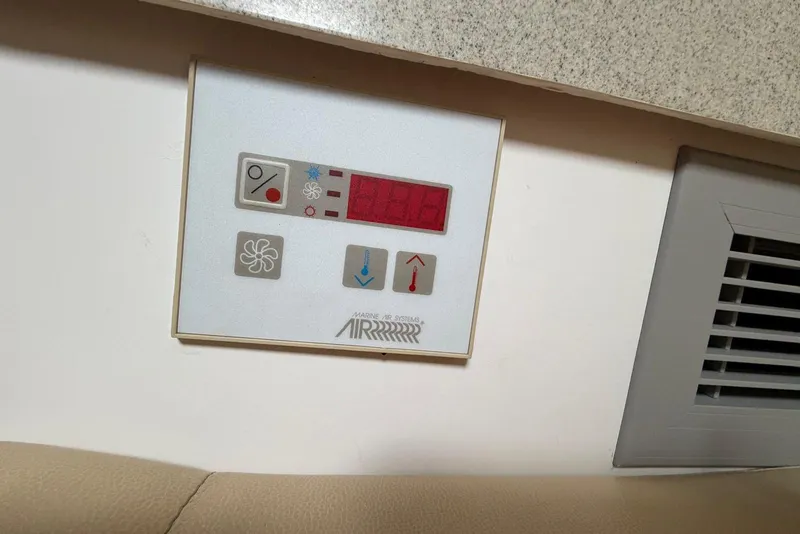 Slide: The Image of Control panel on 2001 Wellcraft 290 Coastal boat, featuring temperature and fan settings. - 94