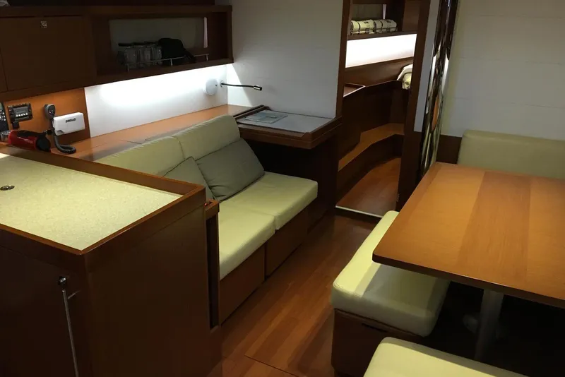 Slide: The Image of Interior of 2013 Beneteau Oceanis 45 yacht with cozy seating and wooden finishes. - 6