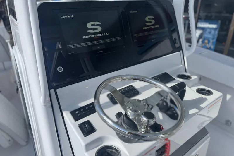 Slide: The Image of 2026 Sportsman Open 282 Center Console dashboard with Garmin displays and steering wheel. - 10