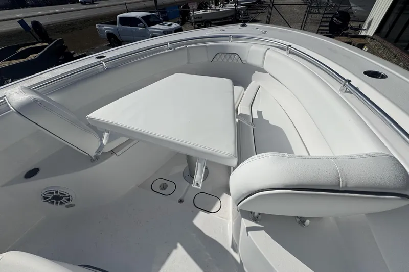 Slide: The Image of 2026 Sportsman Open 282 Center Console boat with white seating and table in the bow area. - 14