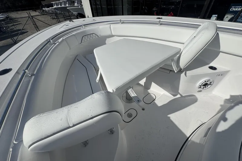 Slide: The Image of 2026 Sportsman Open 282 Center Console boat interior with seating and table. - 15