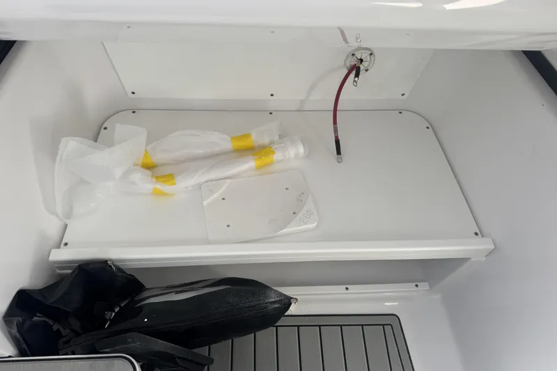 Slide: The Image of 2026 Sportsman Open 282 Center Console storage compartment with equipment and accessories. - 16