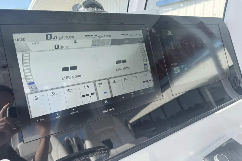 Slide: The Image of 2026 Sportsman Open 282 Center Console dashboard with Garmin display screens. - 19