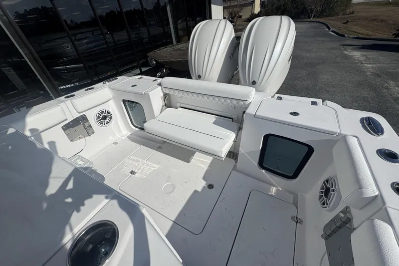 Slide: The Image of 2026 Sportsman Open 282 Center Console boat interior with seating and twin engines. - 21