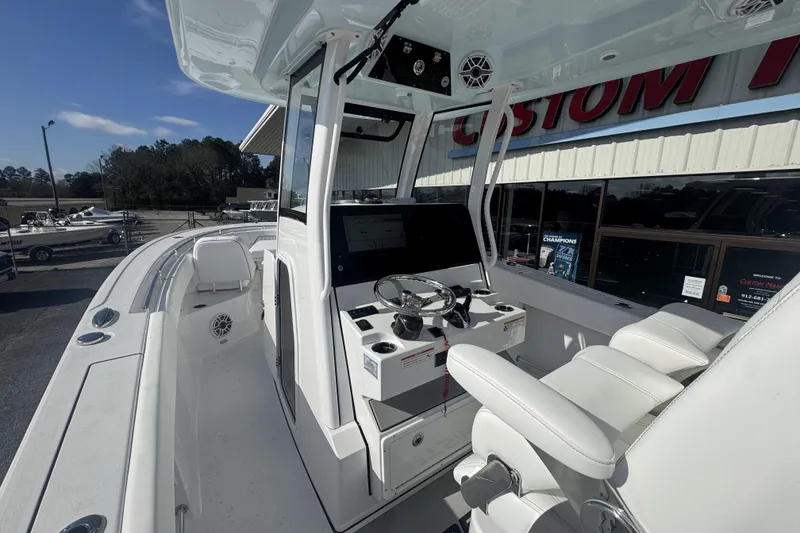 Slide: The Image of 2026 Sportsman Open 282 Center Console boat interior with helm and seating. - 22