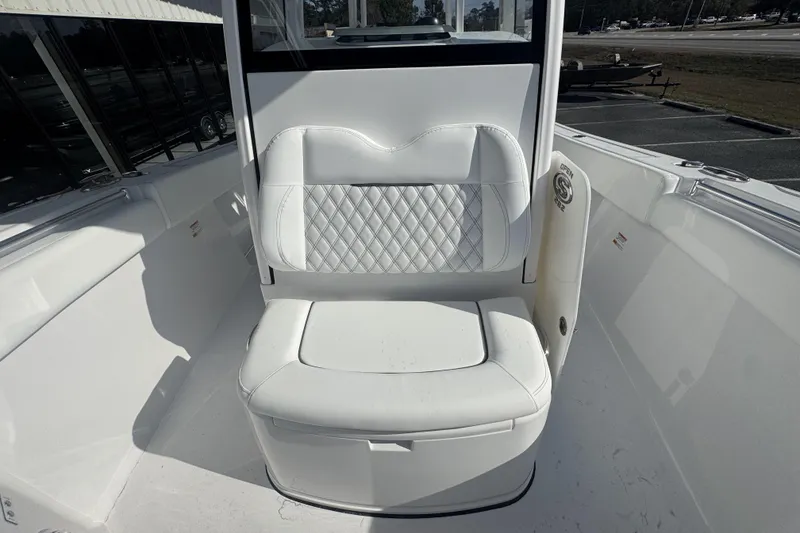 Slide: The Image of 2026 Sportsman Open 282 Center Console boat seat with white upholstery and diamond stitching. - 23