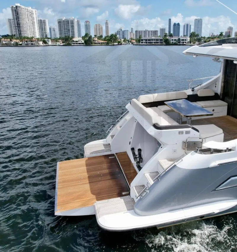 Slide: The Image of 2015 Azimut 55S yacht with open deck, city skyline in background. - 12