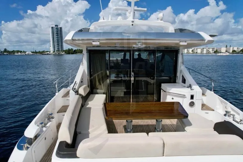 Slide: The Image of 2015 Azimut 55S yacht with spacious deck and seating area on the water. - 15