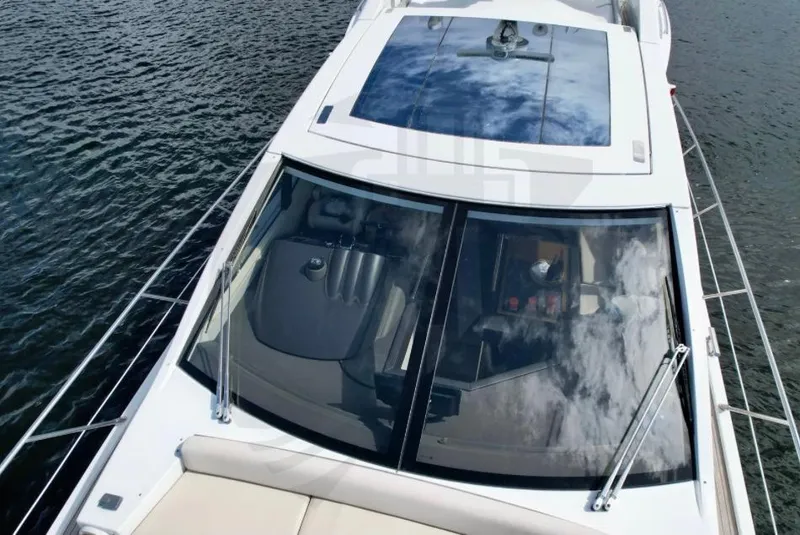 Slide: The Image of Azimut 55S 2015 yacht with sleek design and panoramic windows on the water. - 22