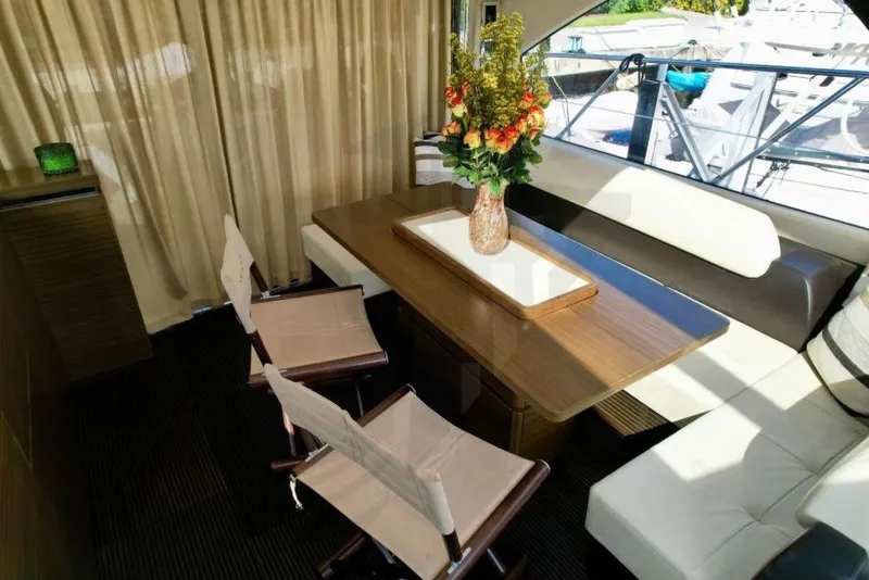 Slide: The Image of Luxurious interior of 2015 Azimut 55S yacht with elegant dining area and floral centerpiece. - 27