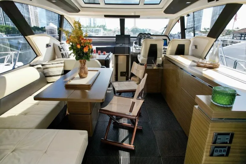Slide: The Image of Luxurious interior of a 2015 Azimut 55S yacht with elegant seating and dining area. - 28