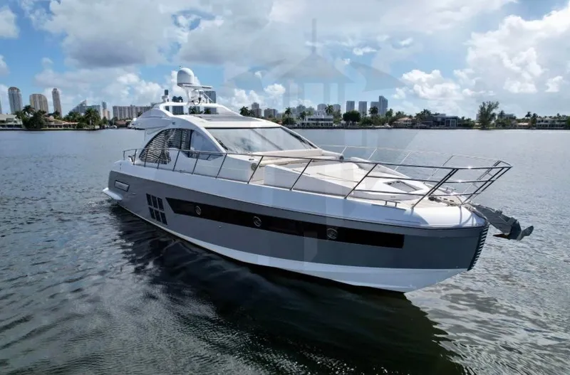 Slide: The Image of 2015 Azimut 55S yacht cruising on a sunny day with city skyline in background. - 4