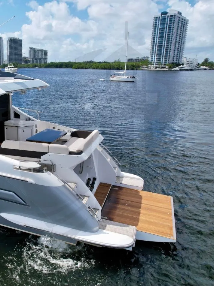 Slide: The Image of 2015 Azimut 55S yacht on water with cityscape background. - 8
