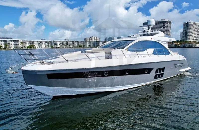 Slide: The Image of 2015 Azimut 55S yacht cruising on a sunny day, cityscape in background. - 87