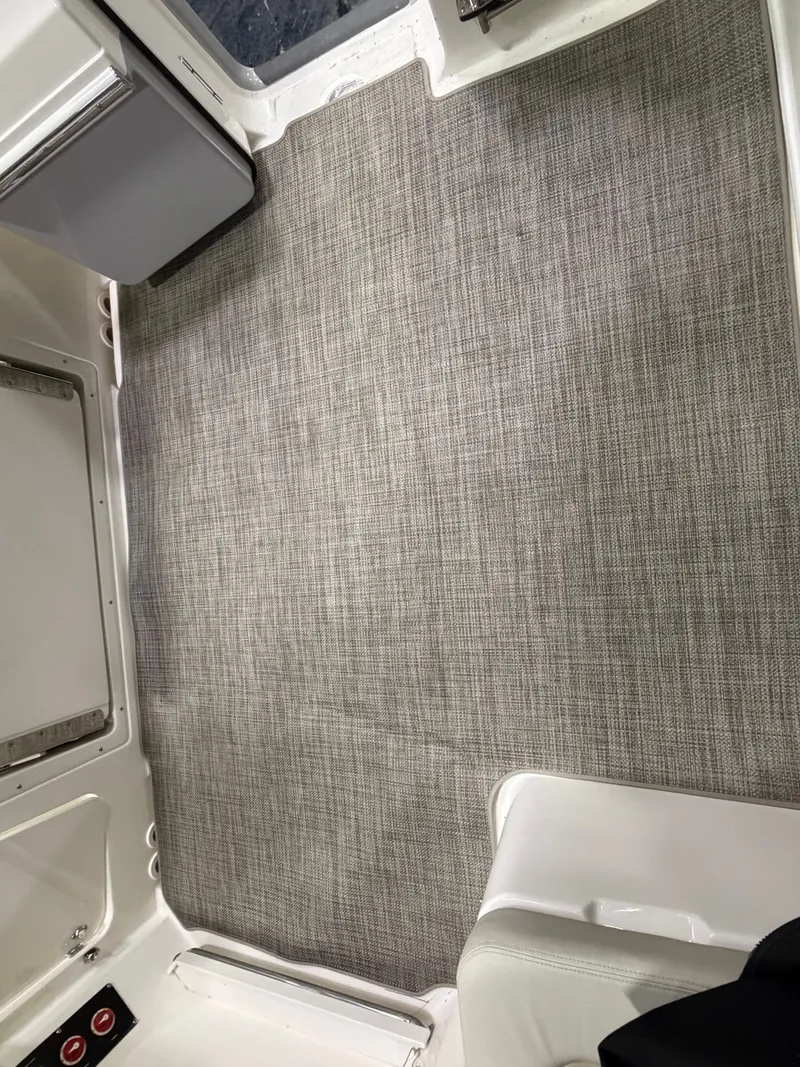 Slide: The Image of Interior of 2025 Boston Whaler 28 Vantage with gray carpet flooring. - 22