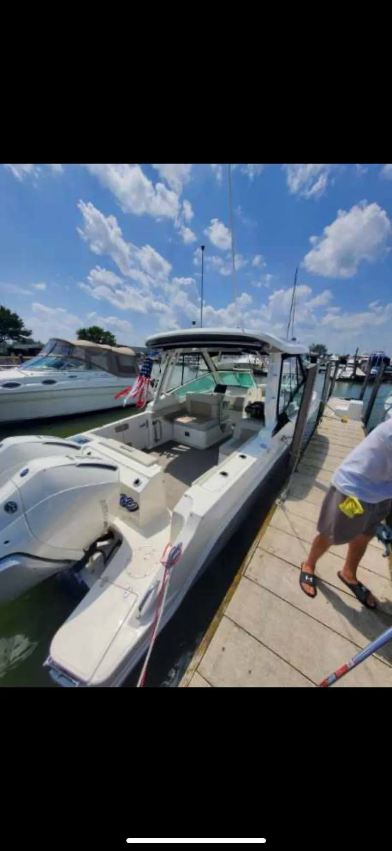 Slide: The Image of Boston Whaler 28 Vantage 2025 docked under sunny skies. - 26