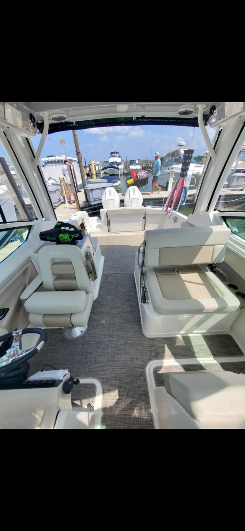 Slide: The Image of Interior of 2025 Boston Whaler 28 Vantage, luxurious design, harbor in background. - 27