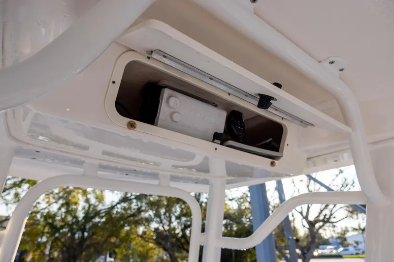 Slide: The Image of 2021 Robalo 226 Cayman boat storage compartment with open hatch, showcasing interior details. - 12