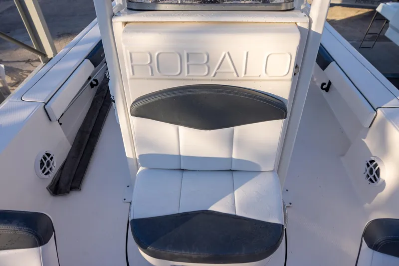 Slide: The Image of 2021 Robalo 226 Cayman boat interior with branded seating and white upholstery. - 15