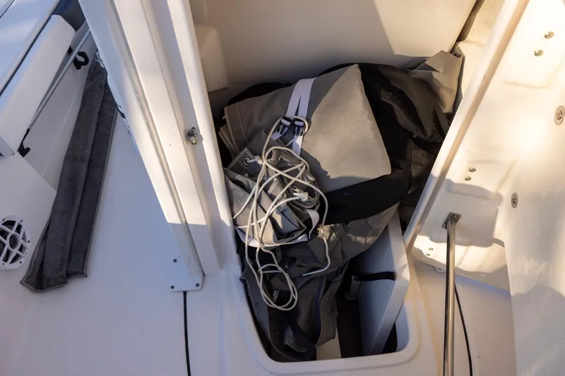 Slide: The Image of Storage compartment on a 2021 Robalo 226 Cayman boat with gear inside. - 16
