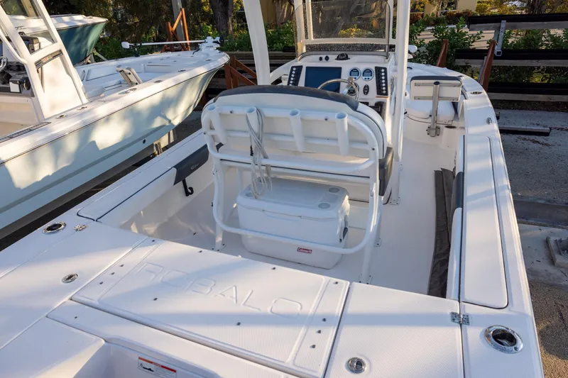 Slide: The Image of 2021 Robalo 226 Cayman boat interior with helm, seating, and storage compartments. - 4