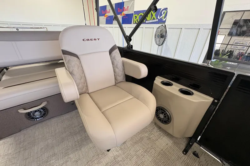 Slide: The Image of Luxurious seating on 2025 Crest Classic 220 boat with cup holders and speaker. - 12