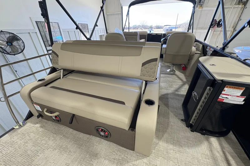 Slide: The Image of 2025 Crest Classic 220 pontoon boat interior with beige seating and modern amenities. - 13
