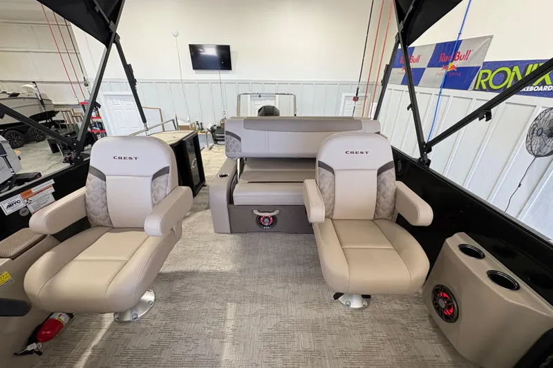Slide: The Image of 2025 Crest Classic 220 boat interior with beige seating and modern design. - 18