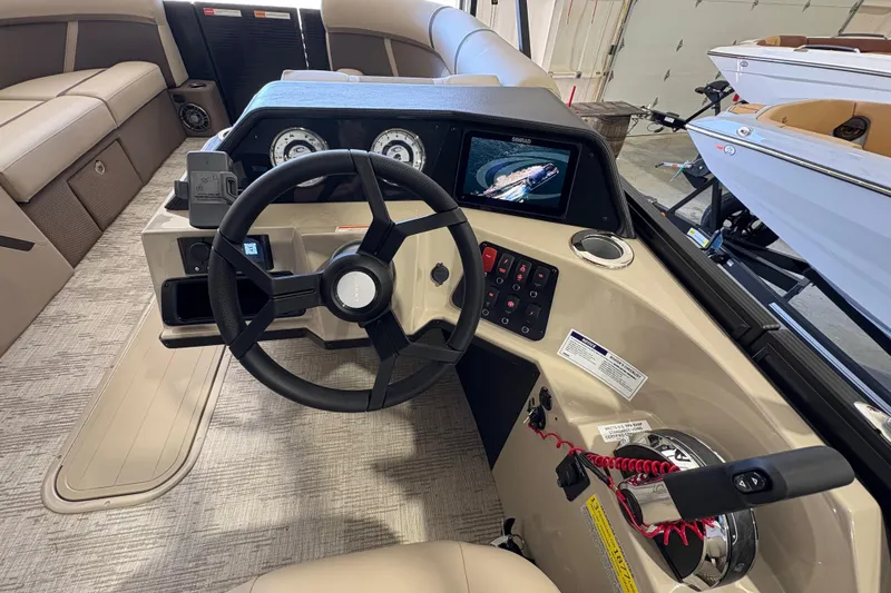 Slide: The Image of 2025 Crest Classic 220 boat dashboard with steering wheel and control panel. - 25