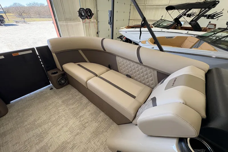 Slide: The Image of 2025 Crest Classic 220 boat interior with beige seating and modern design. - 26