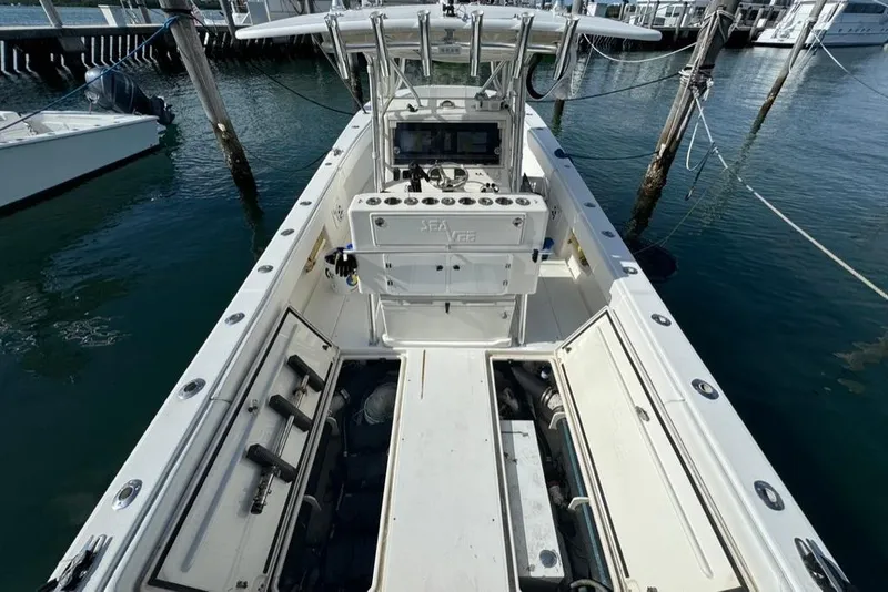 Slide: The Image of 2006 SeaVee 340i Open boat docked, showcasing spacious deck and control console. - 10