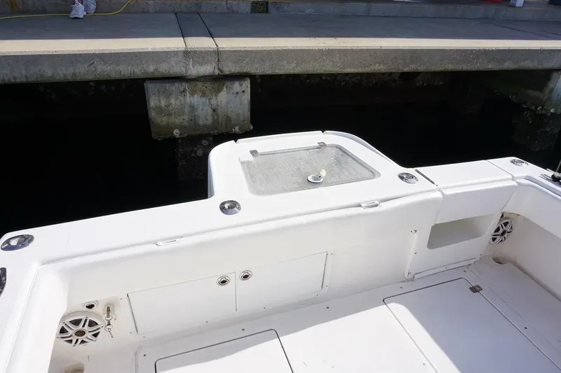 Slide: The Image of 2006 SeaVee 340i Open boat interior, featuring a clean white deck and storage compartments. - 11
