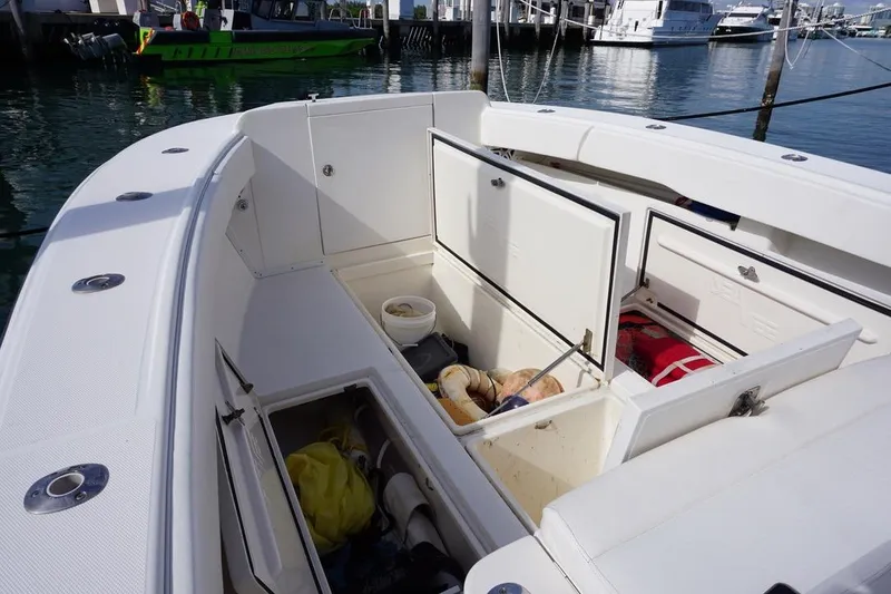 Slide: The Image of 2006 SeaVee 340i Open boat with open storage compartments at a marina. - 14