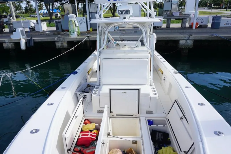 Slide: The Image of 2006 SeaVee 340i Open boat docked, showing open storage compartments and equipment. - 15