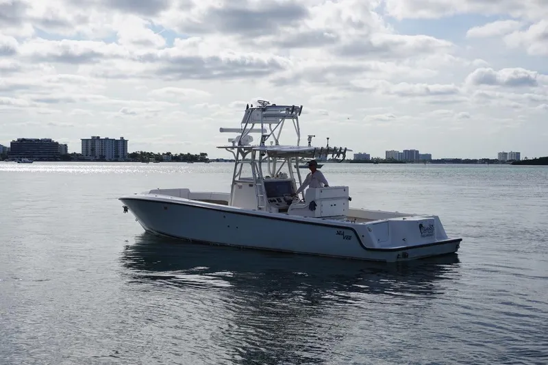 Slide: The Image of 2006 SeaVee 340i Open boat on calm water with city skyline in background. - 3