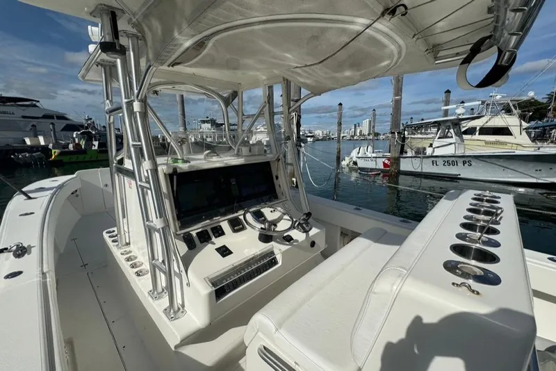 Slide: The Image of 2006 SeaVee 340i Open boat interior with helm, rod holders, and marina view. - 5